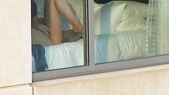 Horny Wife jerking off Perverted husband in front of open window.