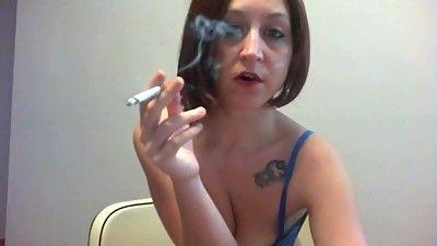 Sexy redhead smoking cigarette
