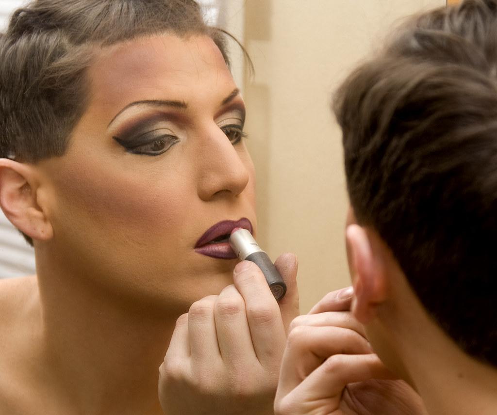 Applying lipstick for transvestite